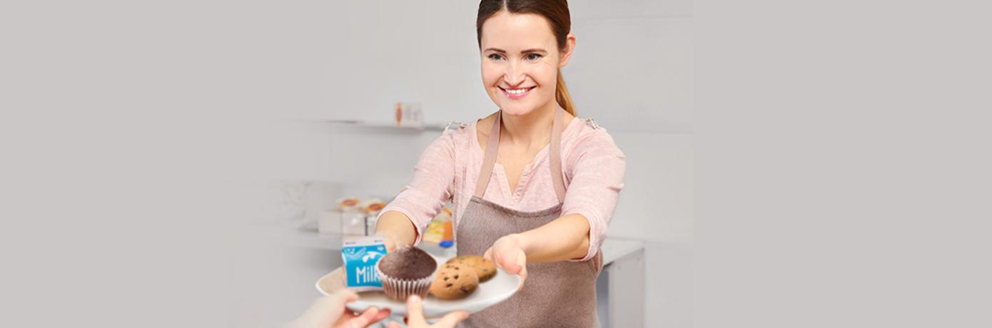 cafeteria worker serving student food