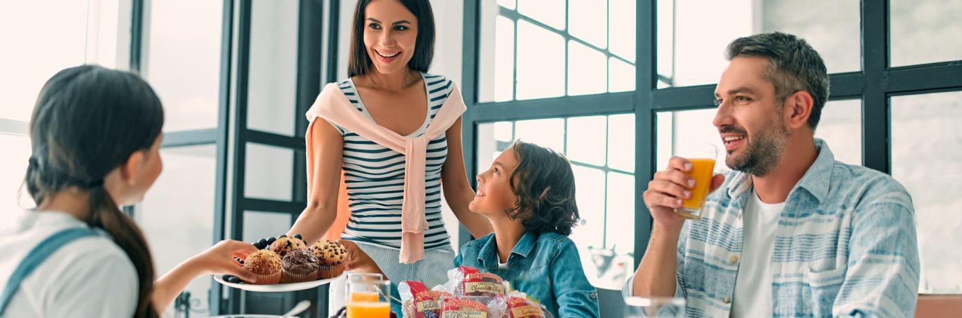 family having muffins and juice