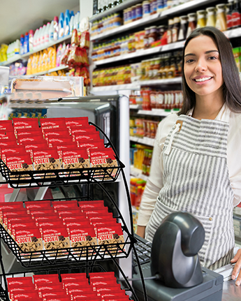 store employee standing next to otis spunkmeyer cookie display