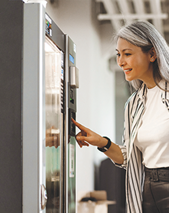 woman purchasing from vending machine