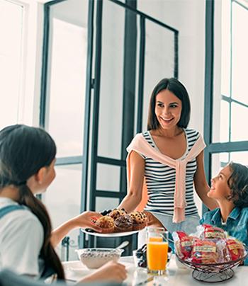 family having muffins and juice